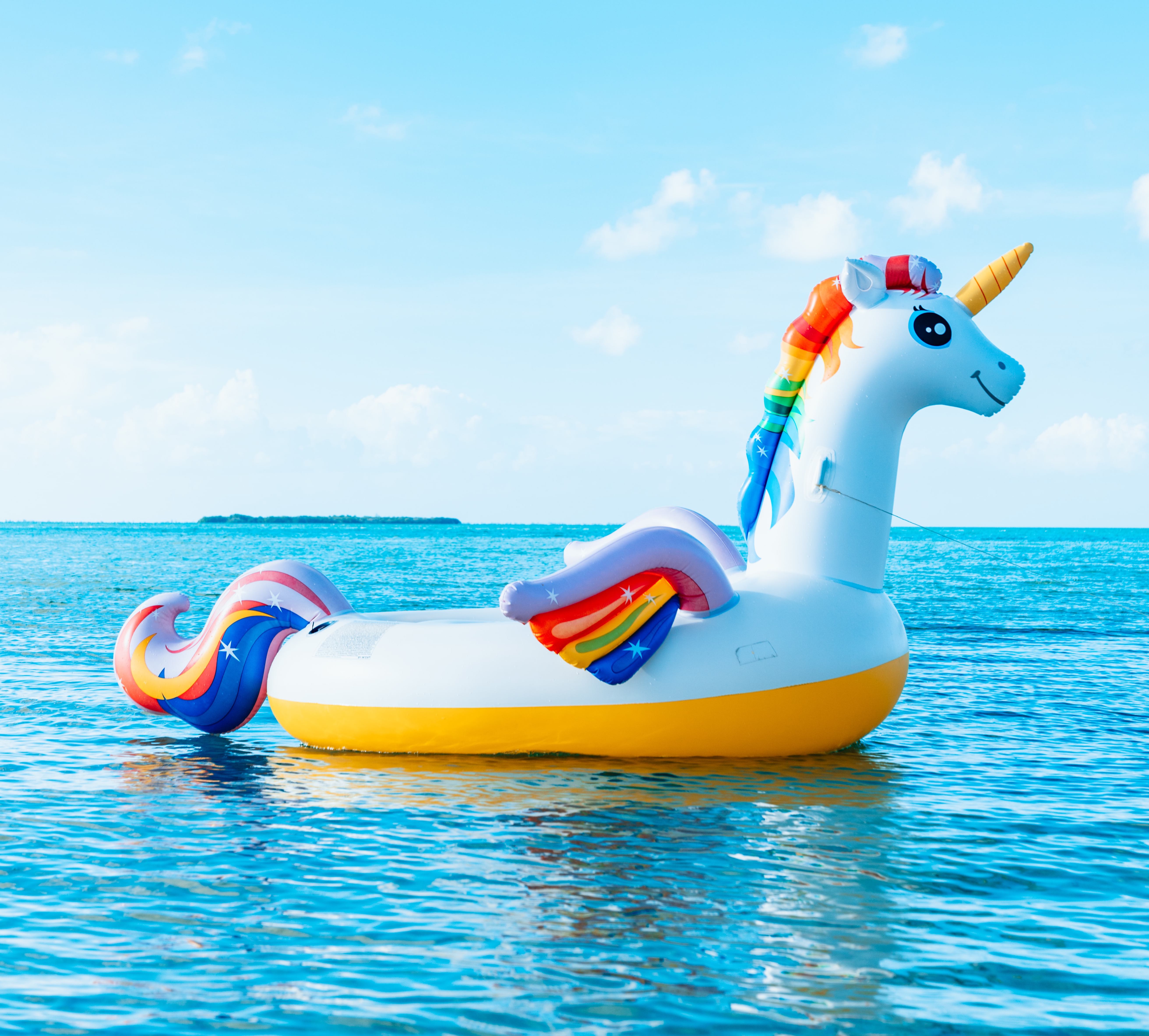 An inflatable unicorn floating in the sea