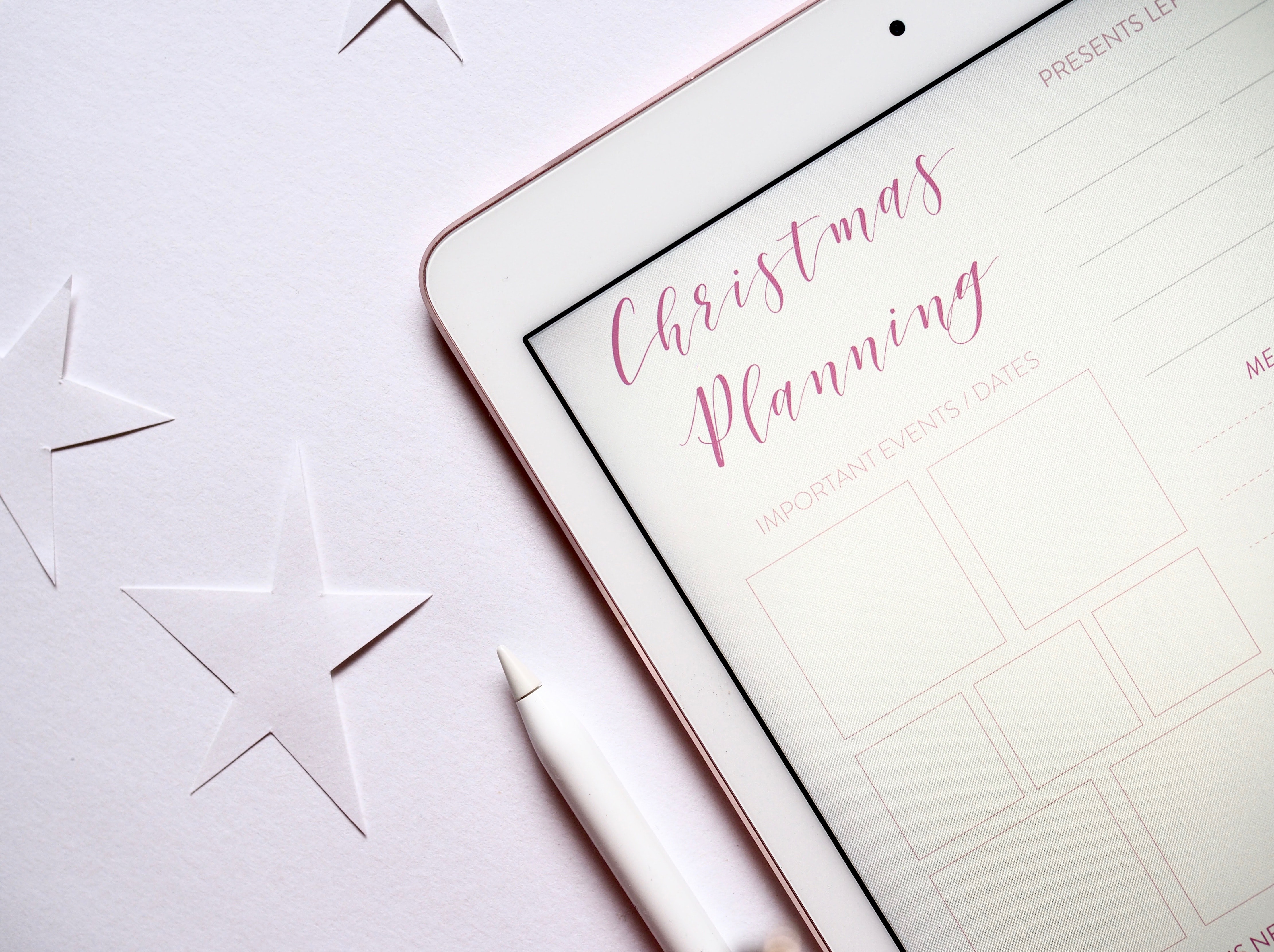 Shows a tablet with a planner on the screen. Words read Christmas planning