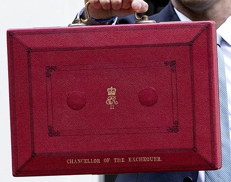 A hand holds the red box with the words Chancellor of the exchequer