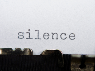The word silence written on a typewriter.