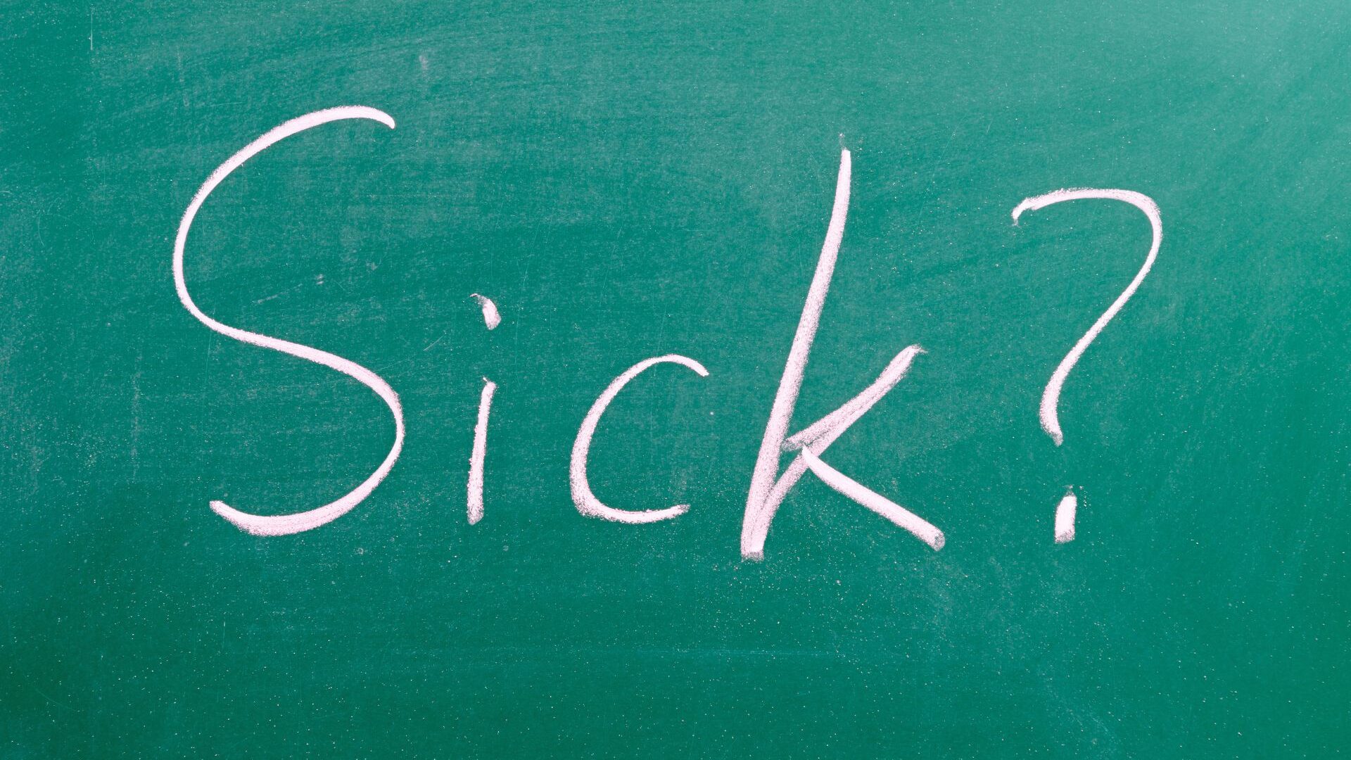 The word 'sick' and a question mark as written on a board.